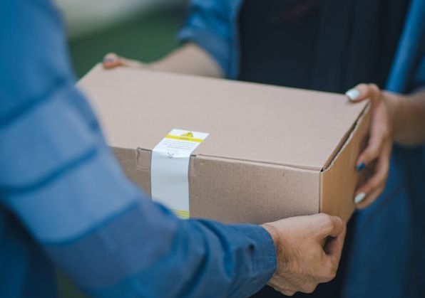 Bild på ett litet paket som överlämnas.